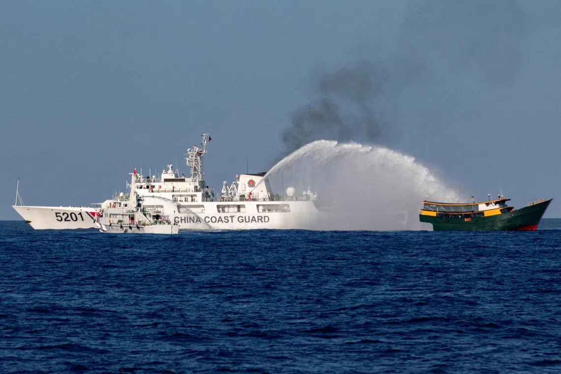 Chinese Coast Guard vessels fire water cannons towards a Philippine resupply vessel Unaizah May 4 on its way to a resupply mission at Second Thomas Shoal in the South China Sea, March 5, 2024. REUTERS/Adrian Portugal/File Photo