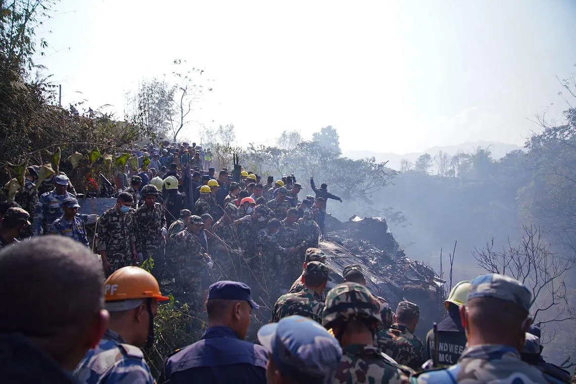 Rescuers gather at the site of a plane crash in Pokhara on Jan 15, 2023.