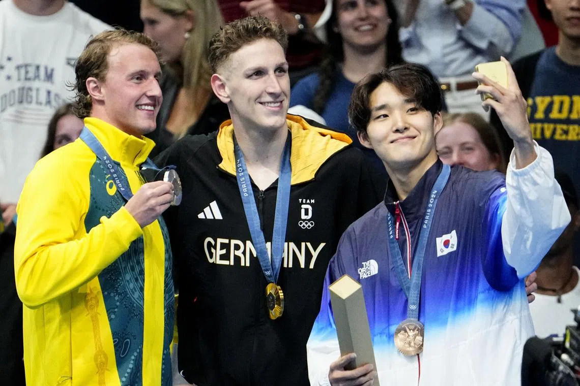 Jul 27, 2024; Nanterre, France; Elijah Winnington (Australia), Lukas Maertens (Germany) and Woomin Kim (Korea) in the men’s 400-meter freestyle medal ceremony during the Paris 2024 Olympic Summer Games at Paris La Défense Arena. Mandatory Credit: Rob Schumacher-USA TODAY Sports