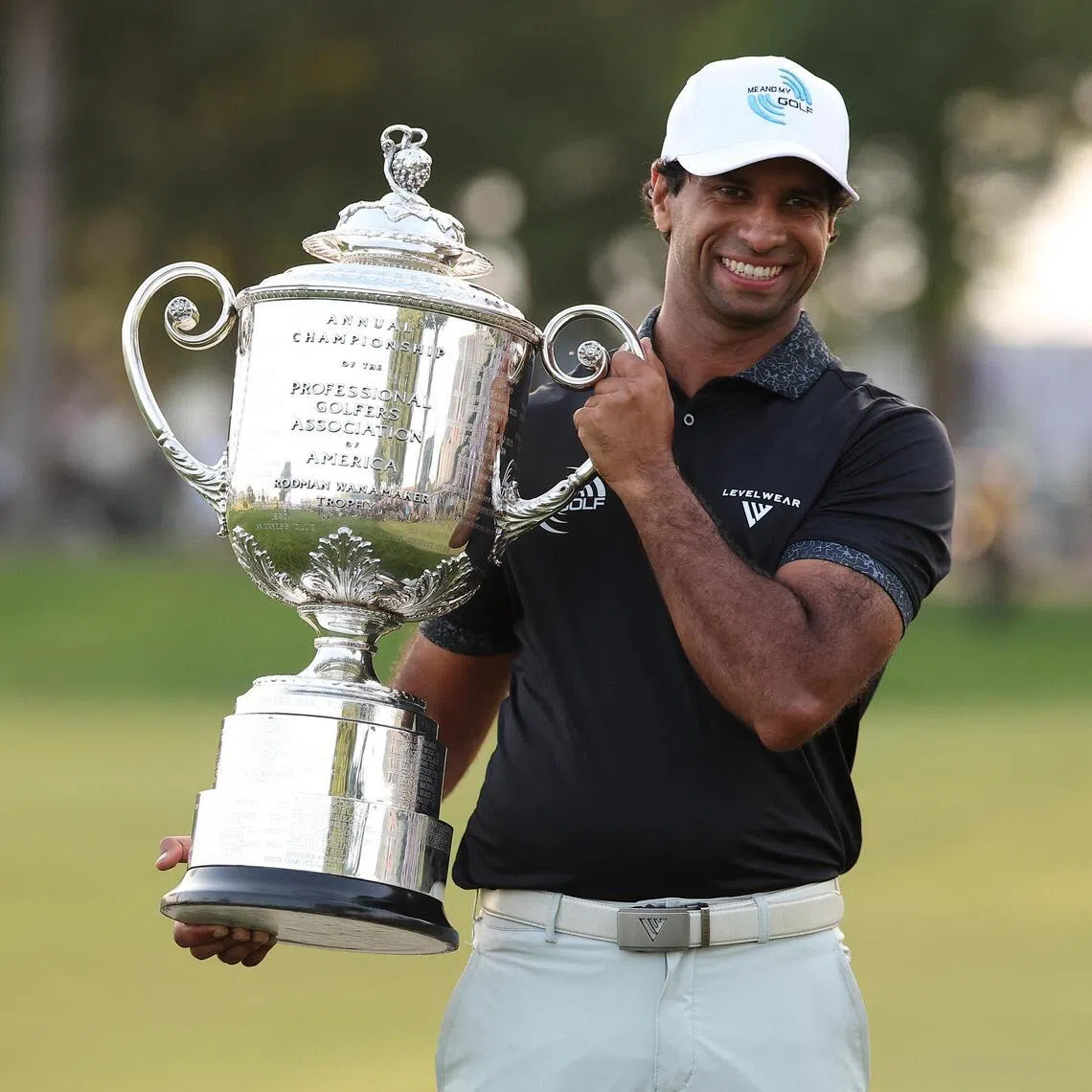 Aaron Rai poses with the trophy after winning the final round of the PGA Championship golf tournament. 