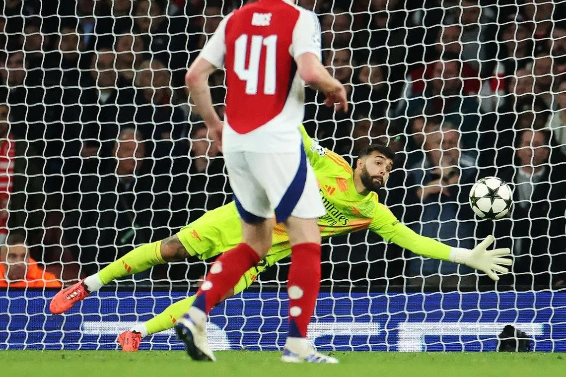 Arsenal goalkeeper David Raya makes a crucial save in the final minutes of the match against Shaktar Donetsk in London.