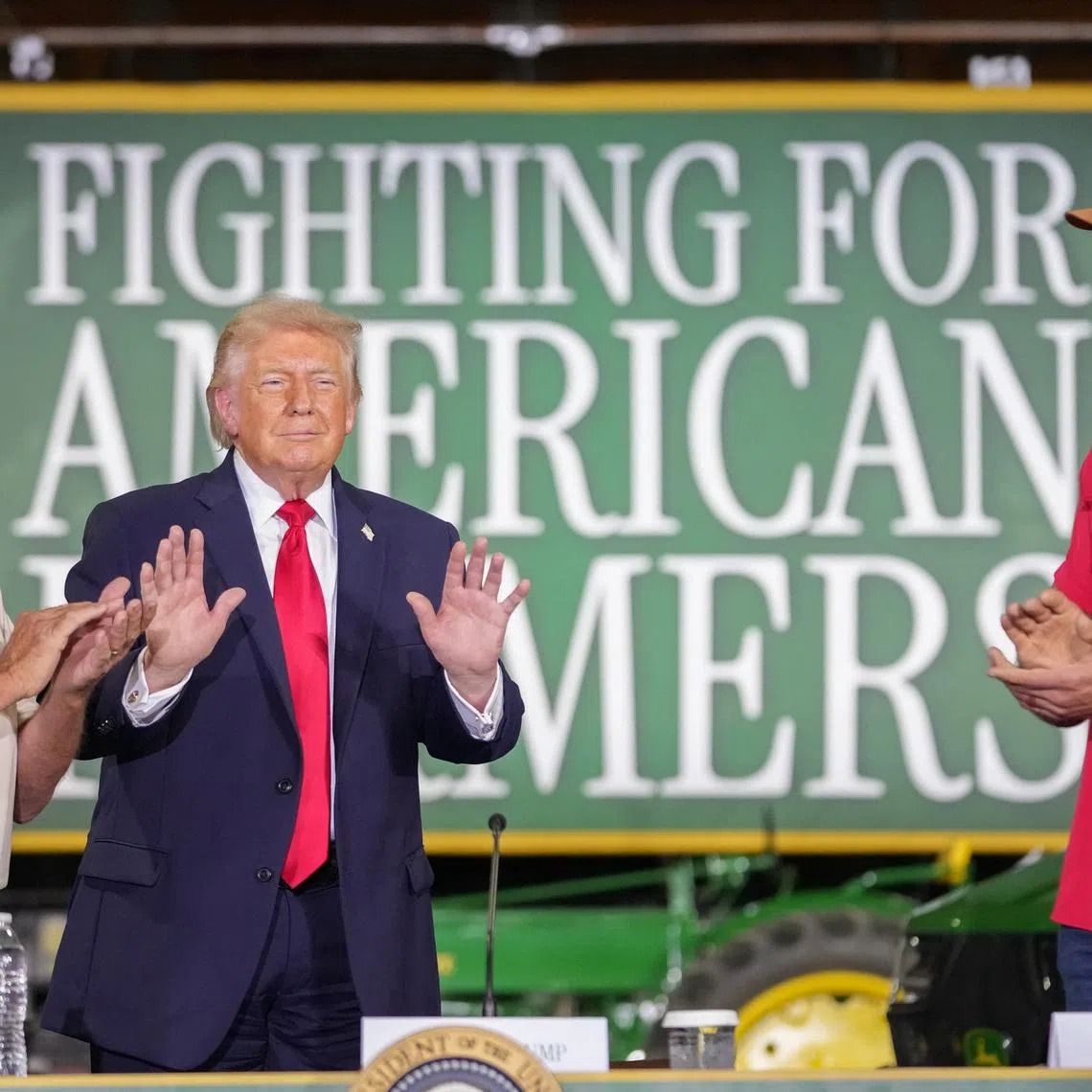 U.S. President Donald Trump stands next to Ken Custer and Joe Thomas during an event at Custer Farms in Chippewa Falls, Wisconsin, U.S., June, 5, 2026. REUTERS/Nathan Howard