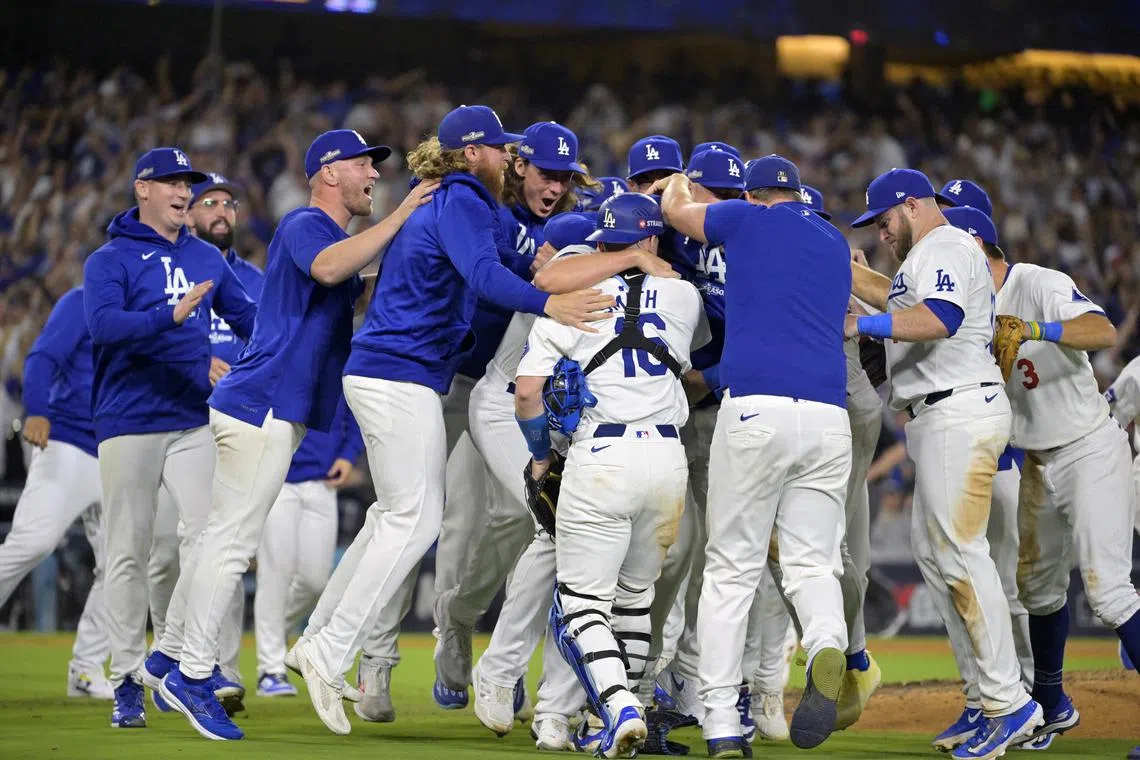 Oct 20, 2024; Los Angeles, California, USA; Los Angeles Dodgers players celebrate after defeating the New York Mets in game six of the NLCS for the 2024 MLB playoffs at Dodger Stadium. Mandatory Credit: Jayne Kamin-Oncea-Imagn Images