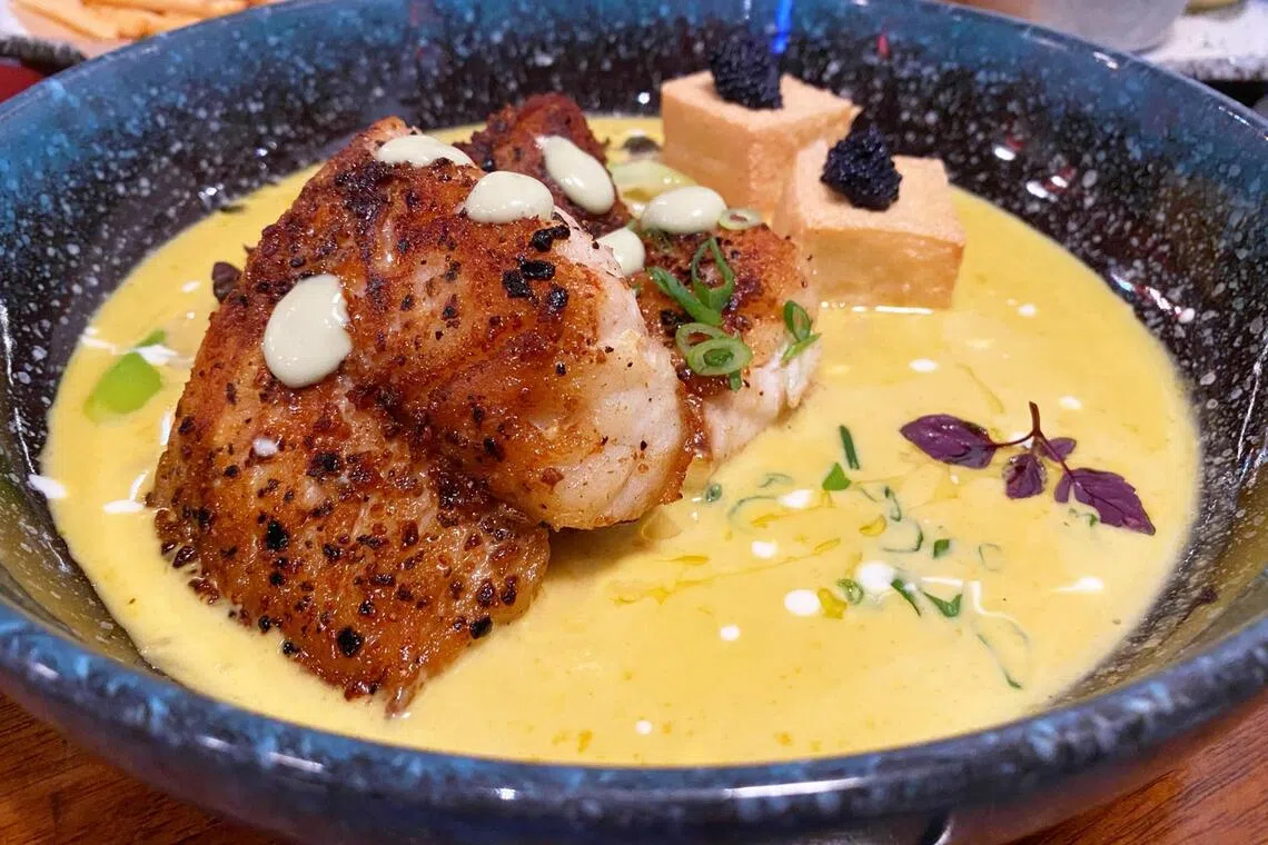 Chef-owner Jonathan Tan prepared a dish of orange-spotted grouper, brought by a customer, in saffron-infused beurre blanc, an off-menu item.