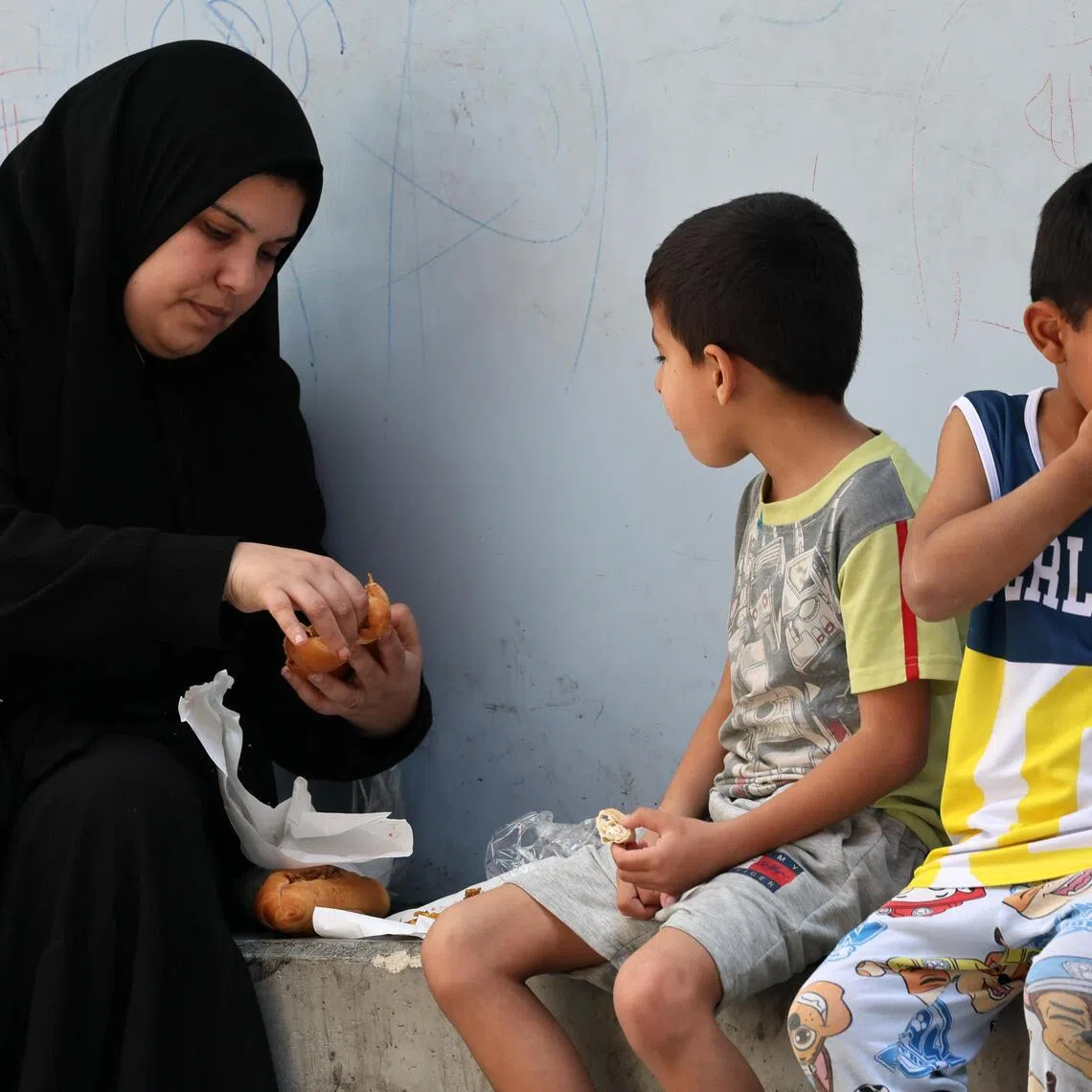 Displaced residents share a meal as they take shelter in a local school after fleeing their homes in southern Lebanon, following Israeli airstrikes, in Beirut, Lebanon, on April 29, 2026.