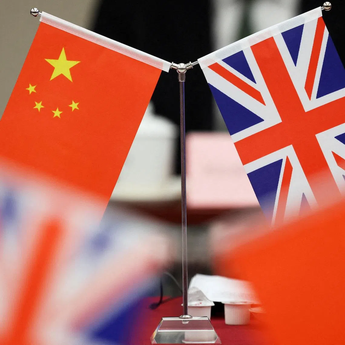 Flags of China and the Union Jack stand during the China-UK Energy Dialogue in Beijing, China March 17, 2025. REUTERS/Florence Lo/Pool