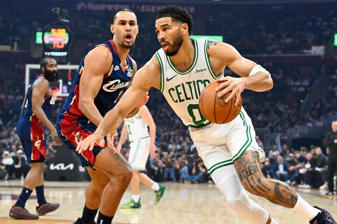 Jayson Tatum of the Boston Celtics drives to the basket around Jaylon Tyson of the Cleveland Cavaliers during the first quarter at Rocket Arena.