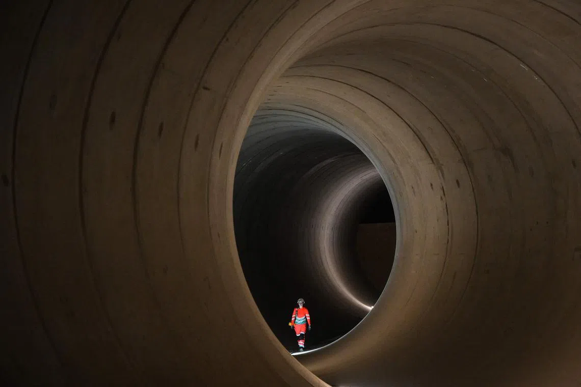 A civil engineer walks inside a seven-metre concrete tunnel at the Thames Tideway building site, in west London.