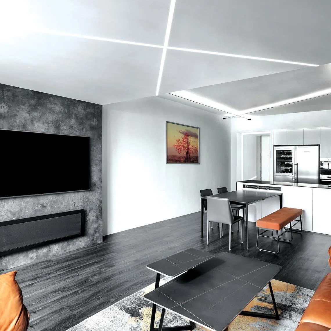 Graphic LED strips criss-cross the ceiling, turning a practical lighting solution into a bold design statement.