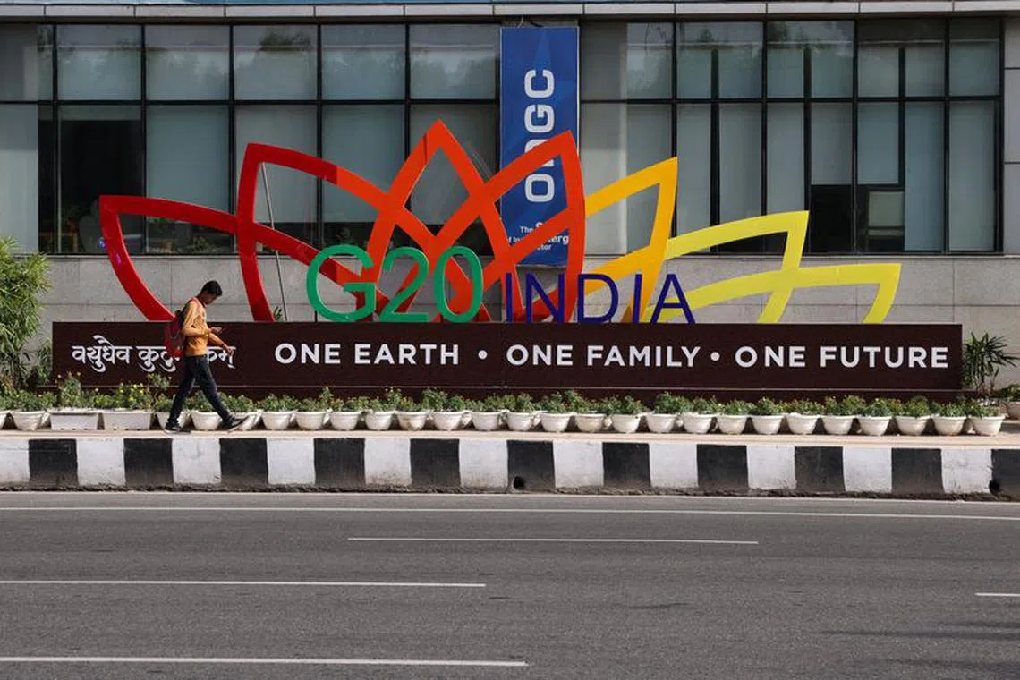 A man walks past a model of the G20 logo outside a metro station ahead of the G20 Summit in New Delhi, India, September 4, 2023. REUTERS/Anushree Fadnavis/File Photo