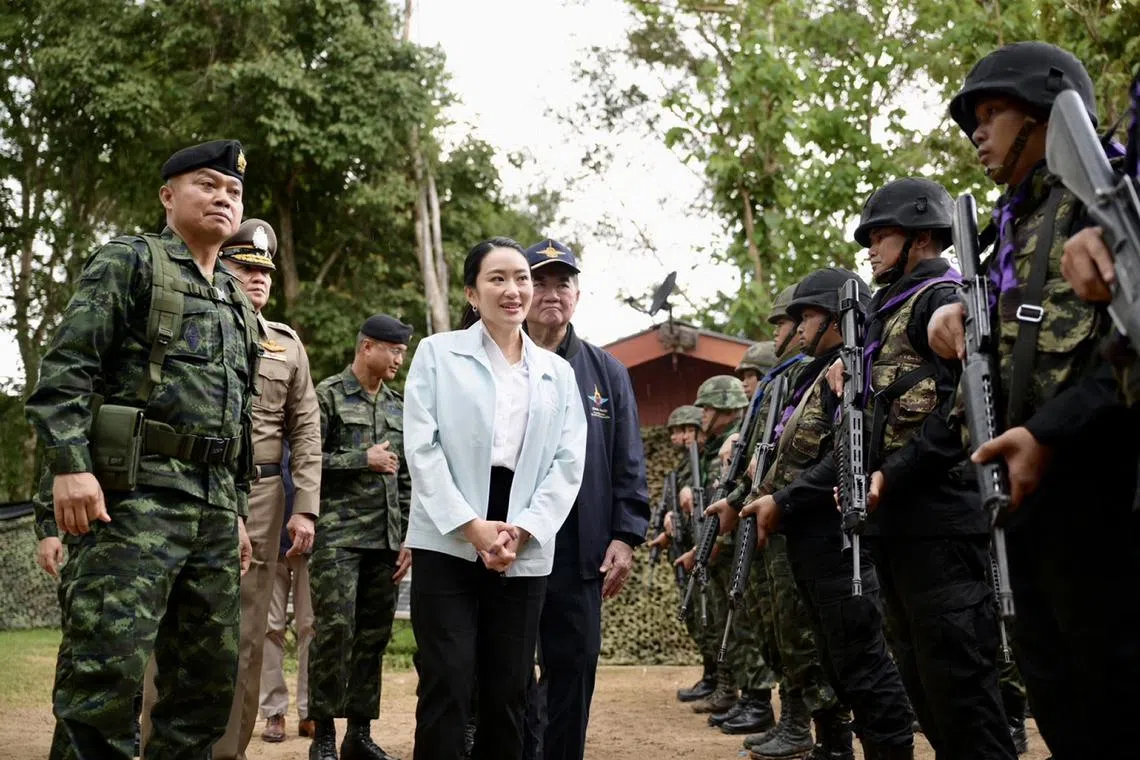 Thai PM Paetongtarn Shinawatra visited troops in northeast Thailand to patch things up with Lieutenant-General Boonsin Padklang (left).