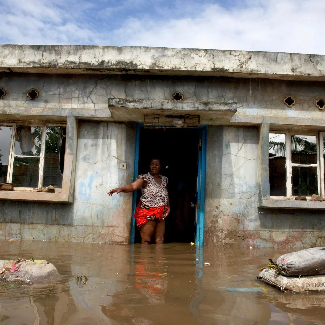 A flood victim stands at her flooded home after weeks of heavy rainfall in Boane District, Maputo, Mozambique, January 19, 2026. REUTERS/Amilton Neves