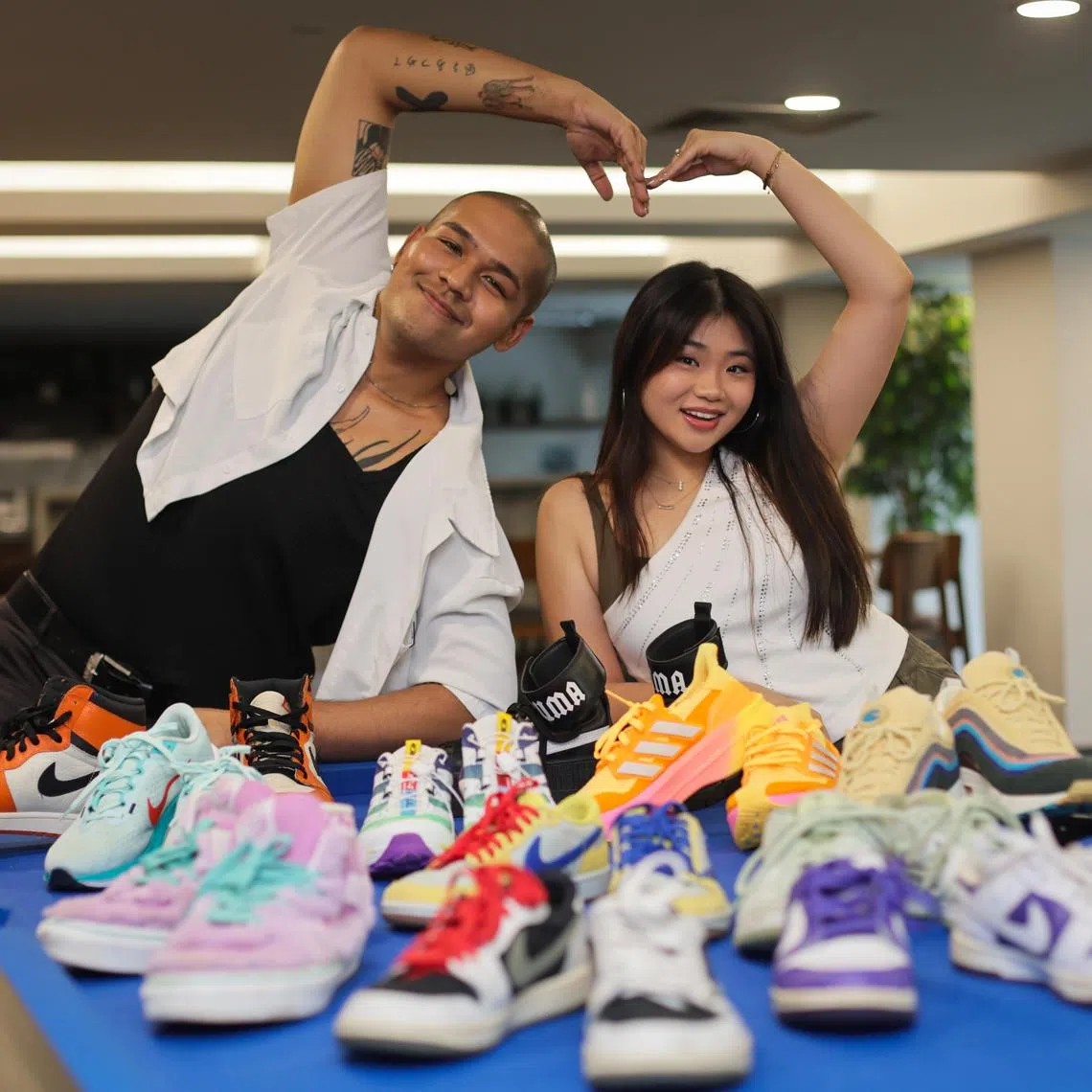 (From left): Profile of Joshua Simon and Shawnia Seah, both deejays from Kiss92, with part of their sneaker collections photographed at News Centre on Nov 29, 2024. 

They also hold iPads to show them designing their own sneakers as part of the Sneaker Con SEA and SPH Media Design Your Sneaker competition, for young people aged 16 to 25. The contest is to be launched in December, and the top designer can win $3,000 cash and limited-edition sneakers (or equivalent).