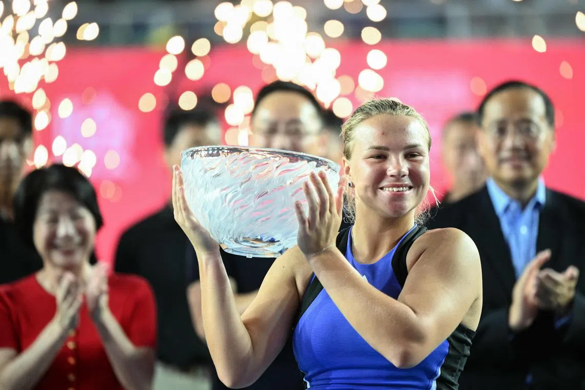 Russia's Diana Shnaider holding up the trophy after beating Britain's Katie Boulter in the women's singles final of the Hong Kong Tennis Open on Nov 3.