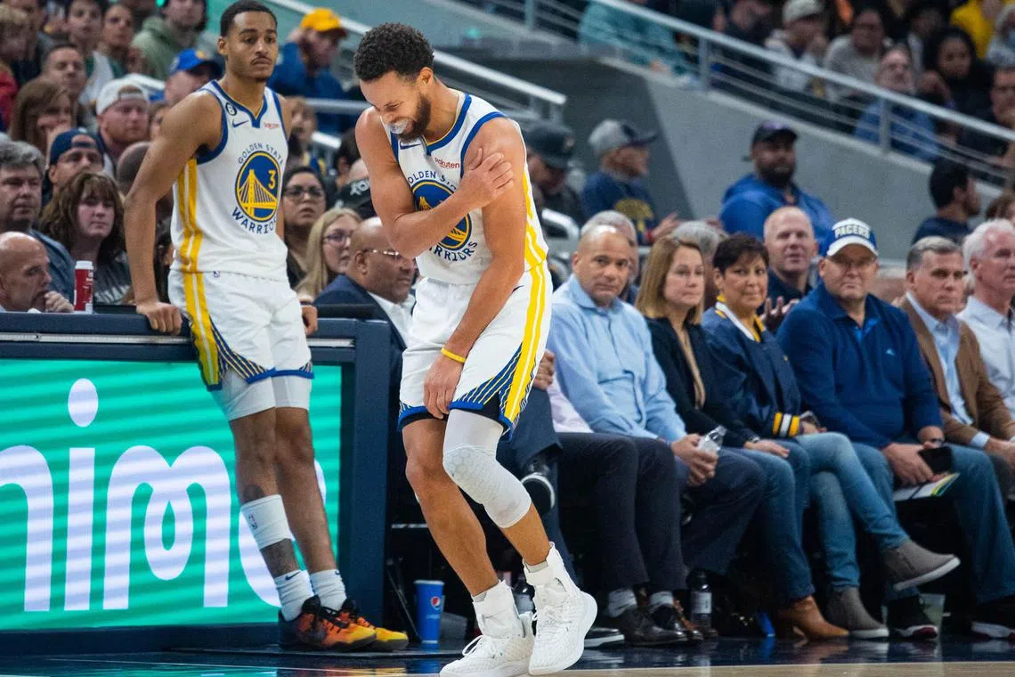 Warriors guard Stephen Curry leaving the game against the Indiana Pacers after hurting his shoulder on Wednesday. 