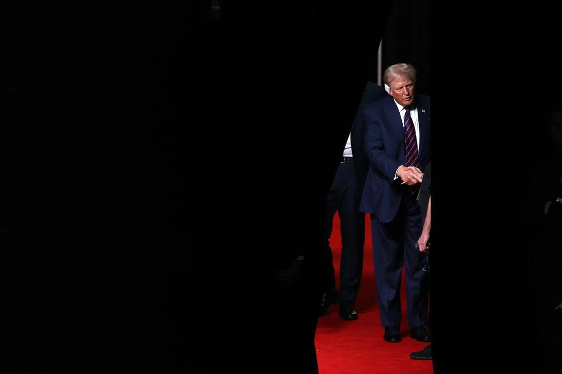 Republican presidential nominee and former U.S. President Donald Trump shakes someone's hand during a walk-through ahead of Day 3 of the Republican National Convention (RNC), at the Fiserv Forum in Milwaukee, Wisconsin, U.S., July 17, 2024. REUTERS/Mike Segar/File Photo