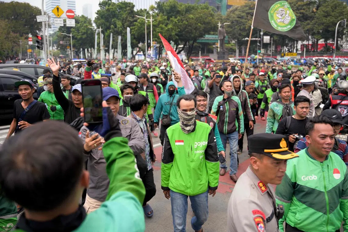 Motorcycle taxi drivers protest against what they described as an inhumane profit-sharing system, in Jakarta on Aug 29.