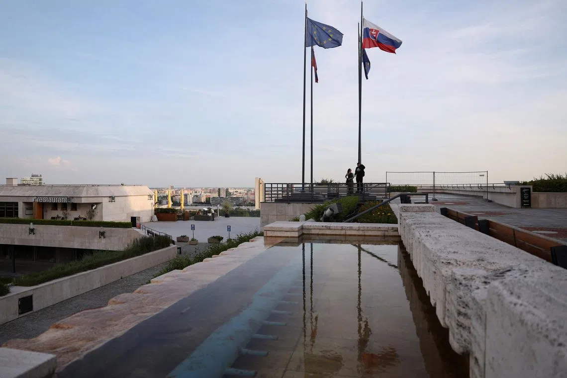 FILE PHOTO: EU and Slovak flags are reflected as they flutter, next to the National Council of Slovakia, in Bratislava, Slovakia, May 20, 2024. REUTERS/Claudia Greco/File Photo