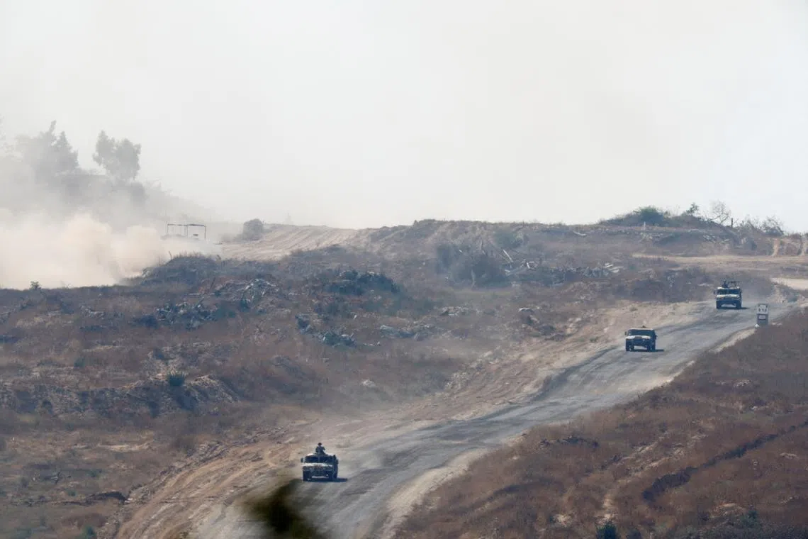 Israeli military vehicles manoeuvre inside the Gaza Strip, amid the ongoing conflict between Israel and Hamas, near the Israel-Gaza border, as seen from Israel, June 5, 2024. REUTERS/Amir Cohen