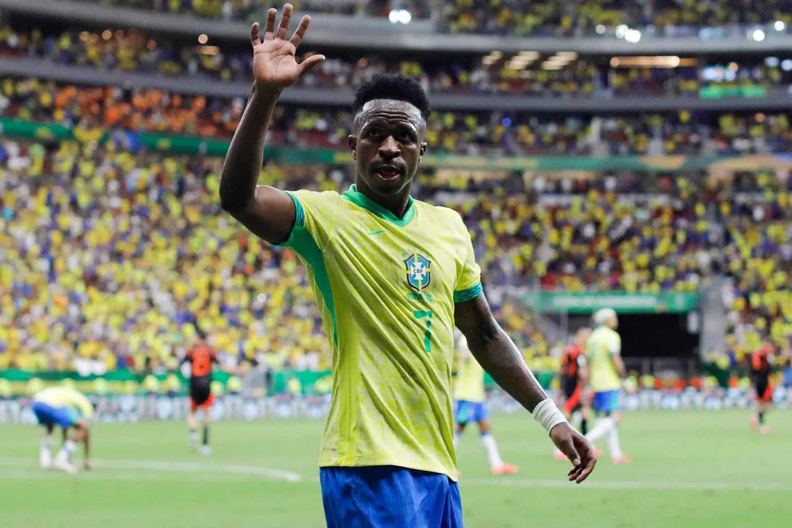 Vinicius Jr waves to the fans during the World Cup qualifier between Brazil and Colombia.