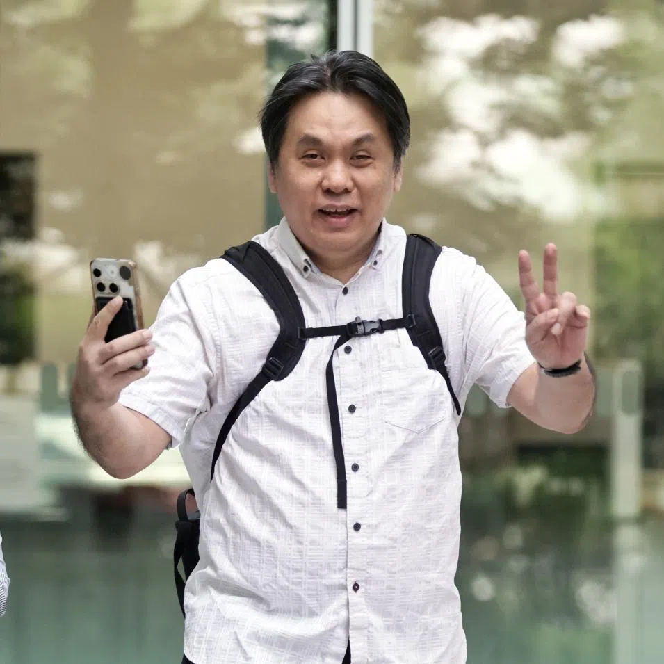 Raymond Ng Kai Hoe at the State Courts on July 6, accompanied by his wife Iris Koh Hsiao Pei, founder of anti-vaccine group Healing the Divide.