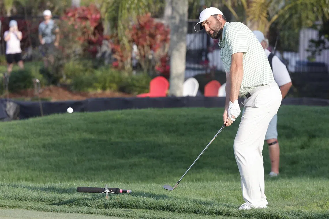 Scottie Scheffler chips onto the 17th green during the third round of the Arnold Palmer Invitational.