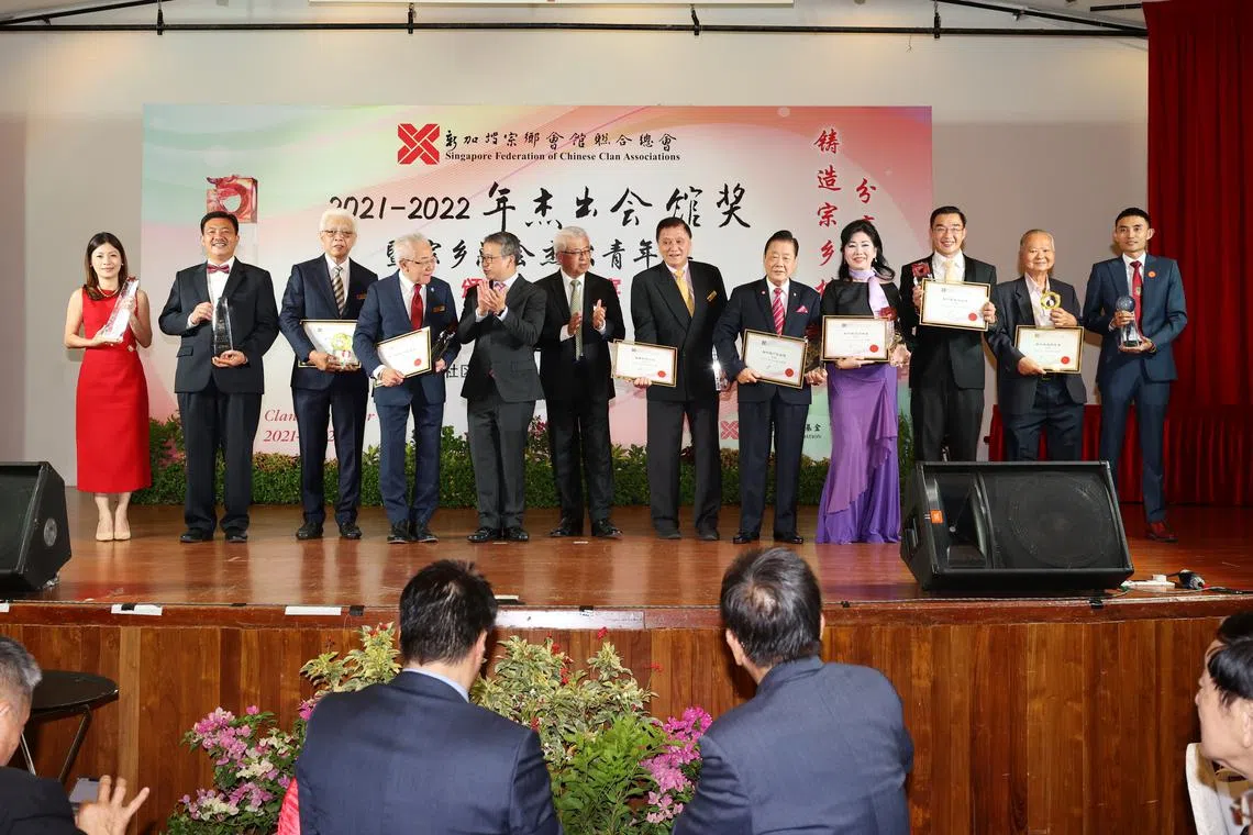 Minister Edwin Tong (fifth from left) and Singapore Federation of Chinese Clan Associations president Thomas Chua (sixth from left) with award recipients.