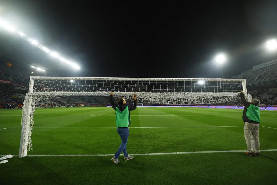 FILE PHOTO: Soccer Football - LaLiga - FC Barcelona v Osasuna - Estadi Olimpic Lluis Companys, Barcelona, Spain - March 8, 2025 Groundstaff roll up the goal net after the match was postponed due to the death of Carlos Minarro Garcia, a member of FC Barcelona's medical staff REUTERS/Albert Gea/File Photo