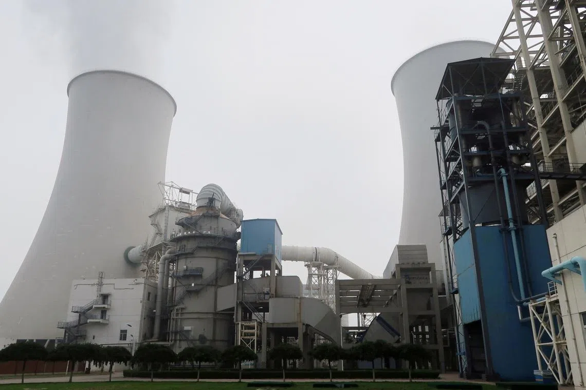 FILE PHOTO: Water vapour rises from a cooling tower of a China Energy ultra-low emission coal-fired power plant during a media tour, in Sanhe, Hebei province, China July 18, 2019. Picture taken July 18, 2019.  REUTERS/Shivani Singh/File Photo