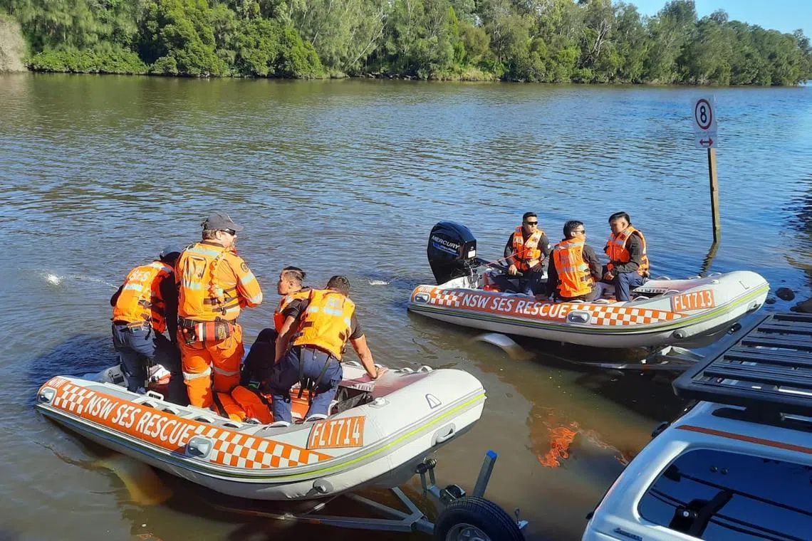 Rescuers from SCDF's elite Disaster Assistance and Rescue Team familiarising themselves with the equipment used by their counterparts.