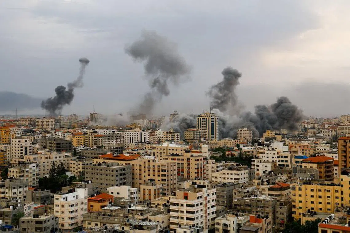 FILE PHOTO: A general view shows smoke as it rises following Israeli strikes in Gaza, October 9, 2023. REUTERS/Mohammed Salem/File Photo