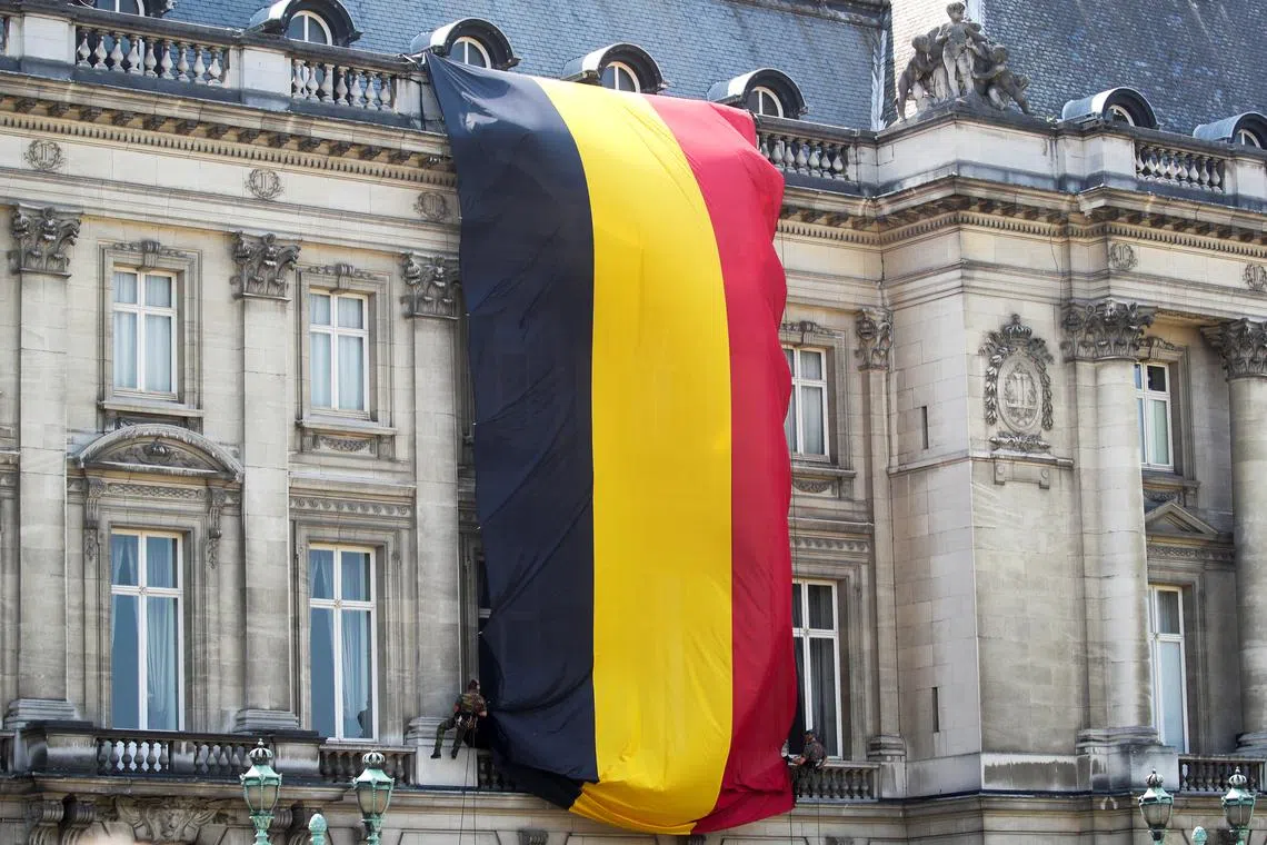 FILE PHOTO: A large Belgium's flag is unfolded in Brussels, Belgium July 21, 2021. REUTERS/Yves Herman/ File Photo