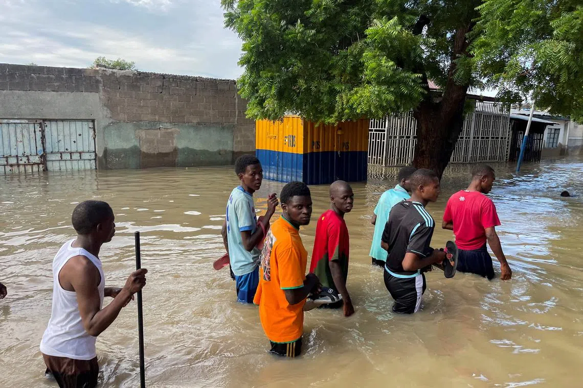 FILE PHOTO: Residents walk in a flooded area during rescue operations in Maiduguri, northern Borno state, Nigeria September 12, 2024. REUTERS/Ahmed Kingimi/File Photo