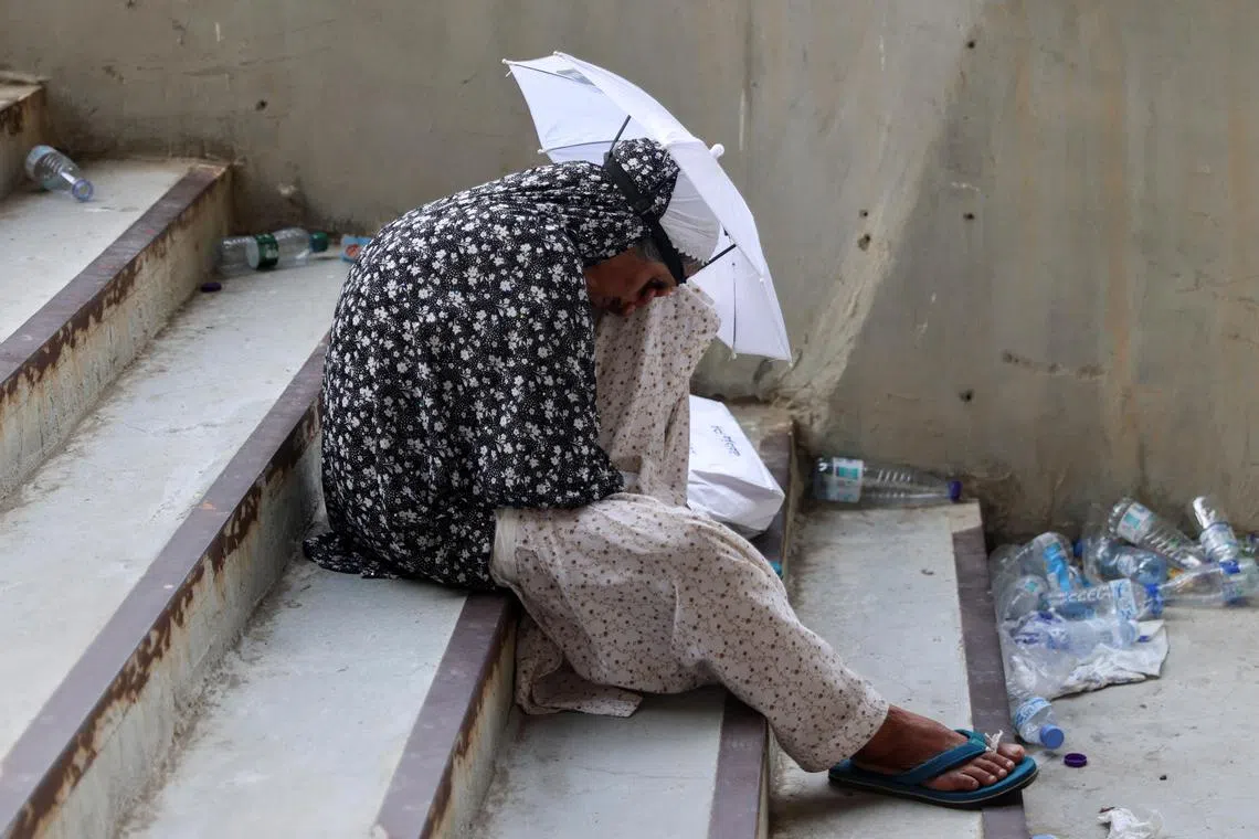 A pilgrim using an umbrella as a shield from the sun, during the annual haj pilgrimage, in Mina, Saudi Arabia, on June 16.