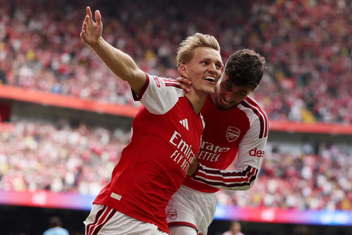 Arsenal’s Martin Odegaard celebrates scoring their third goal with Kai Havertz.