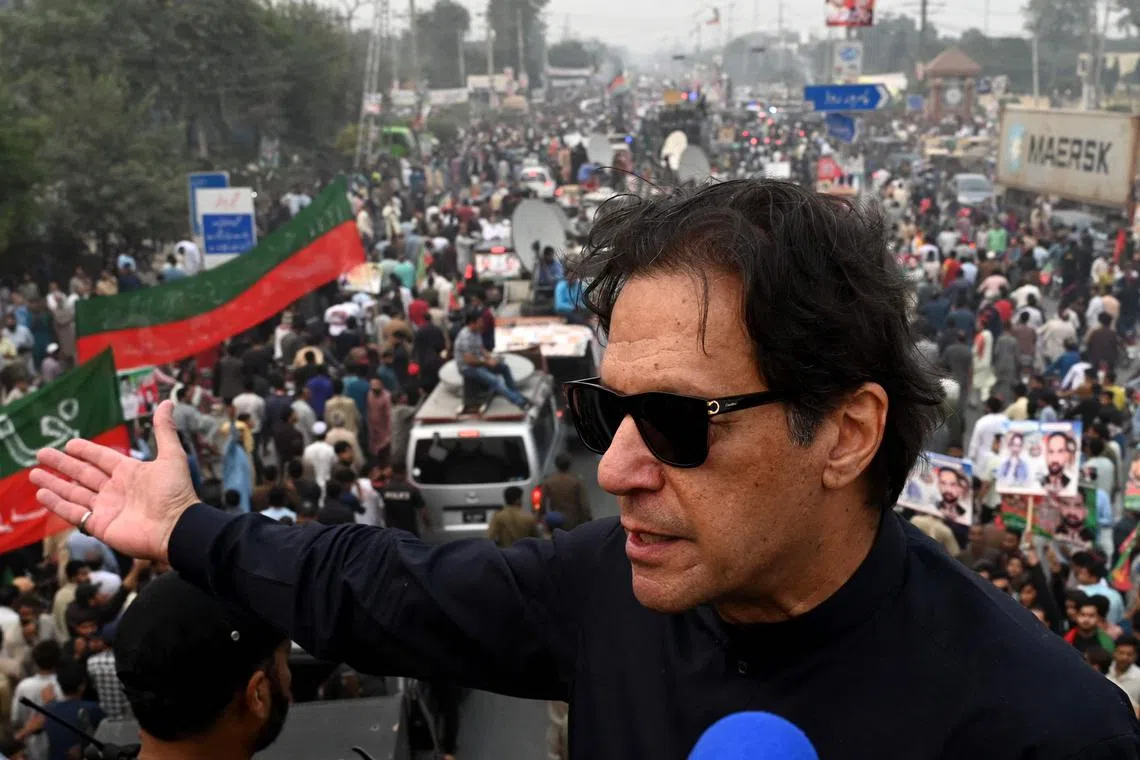 In this photograph taken on November 1, 2022, Pakistan's former prime minister Imran Khan speaks while taking part in an anti-government march in Gujranwala. 