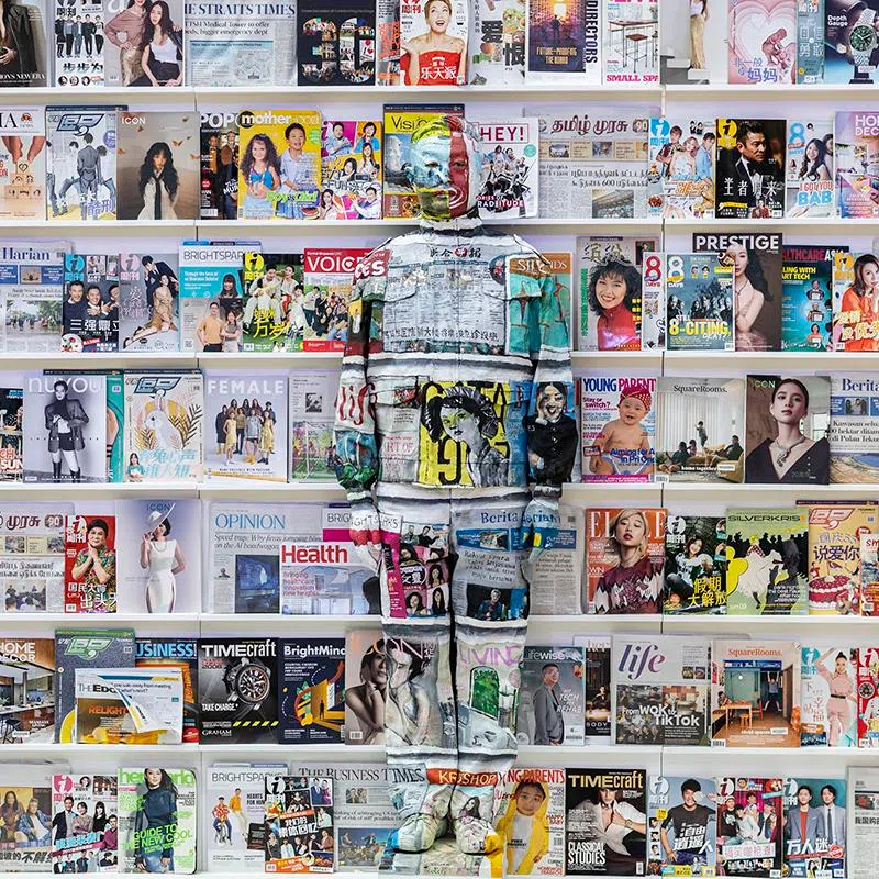 ST20250914_202513400350/pixliubolin/Brian Teo/Beijing-based contemporary artist Liu Bolin is photographed against a backdrop of SPH Media newspapers and magazines during the Canvas of Hope initiative by the Rare Disorders Society (Singapore) [RDSS] at the Glass Dome, Far East Square, on Sept 14, 2025. The art-meets-advocacy campaign, Liu’s first collaboration with a Singapore charity, aims to spotlight the lives of children with rare diseases and raise S$1 million for therapy, medical equipment and caregiving support for over 200 patients. For Canvas of Hope 2025, a Singapore chapter was created using The Straits Times and other SPH titles, marking both The Straits Times’ 180th anniversary and Singapore’s 60th year of independence. The artwork honours the media’s role in chronicling the nation’s stories while prompting reflection on which narratives are visible and which remain unseen. ST PHOTO: BRIAN TEO