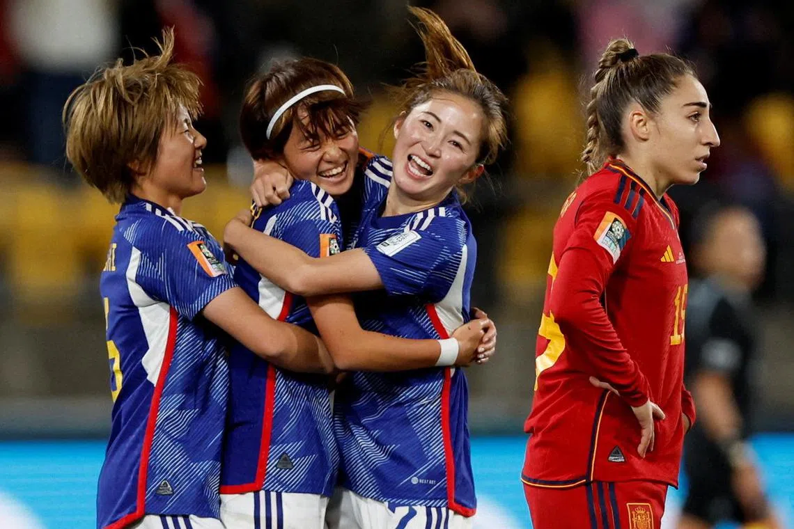 Japan's Hinata Miyazawa celebrates scoring their third goal with Risa Shimizu and Honoka Hayashi as Spain's Olga Carmona looks away. Japan won 4-0 to top Women’s World Cup Group C.
