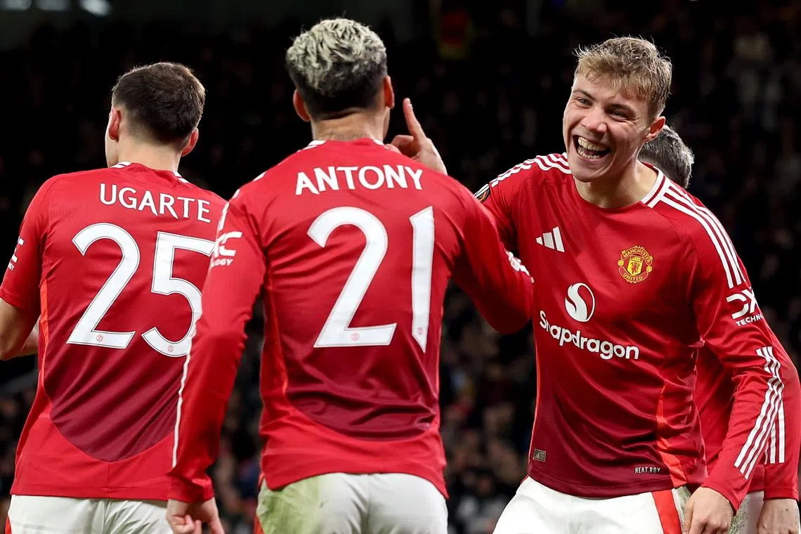 Rasmus Hojlund (right), of Manchester United, celebrates with teammate Antony after scoring his team's third goal.
