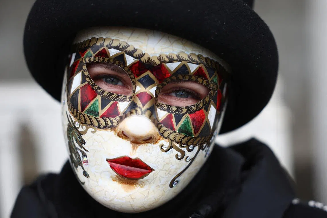 A masked reveller taking part in the Venice carnival in St. Mark's Square in Venice, Italy, Jan 27, 2024. 