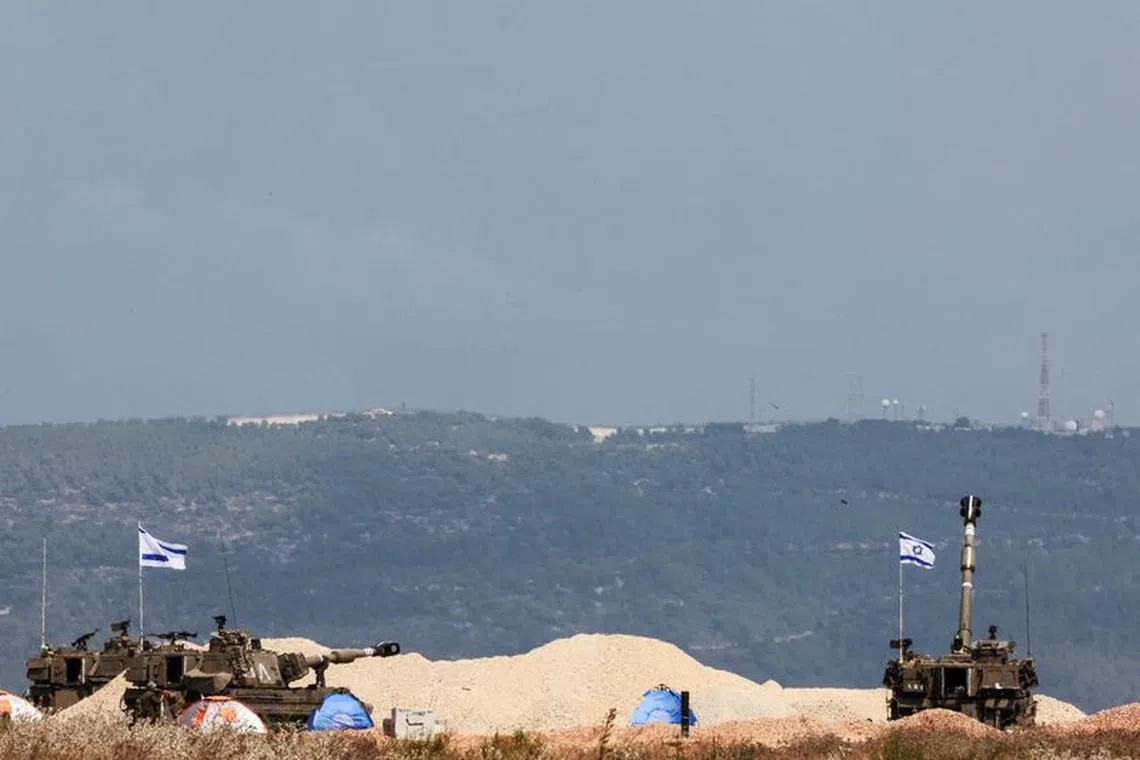 Israeli tanks are positioned near Israel's border with Lebanon, in northern Israel, October 10, 2023. REUTERS/Ammar Awad/File Photo