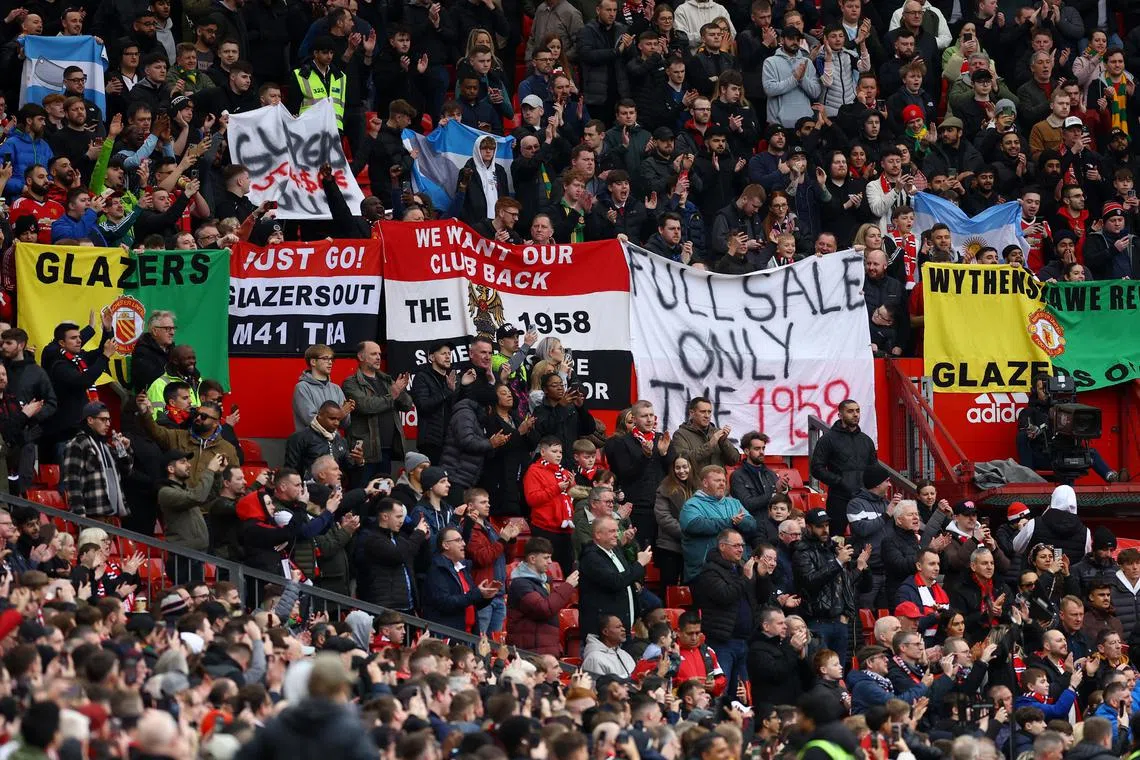A view of banners and signs displayed by Manchester United fans inside the stadium targeting owners the Glazer family before the match against Fulham.