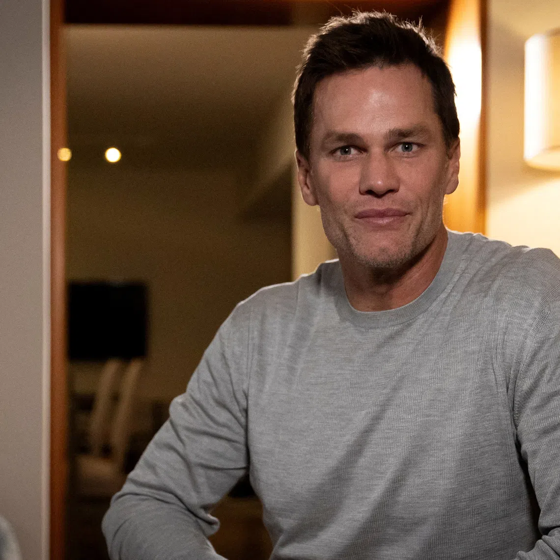 FILE PHOTO: Former National Football League (NFL) quarterback and owner of Team Brady, an E1 electric powerboat series team, Tom Brady poses for a portrait during an interview with Reuters, ahead of the UIM E1 World Championship finale, in Miami Beach, Florida, U.S., November 6, 2025. REUTERS/Marco Bello/File Photo