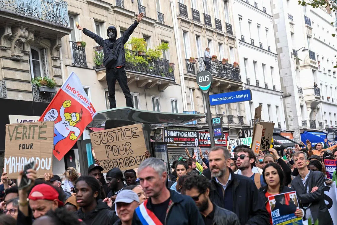 Protesters attend a "united march" against police brutality,  in Paris.