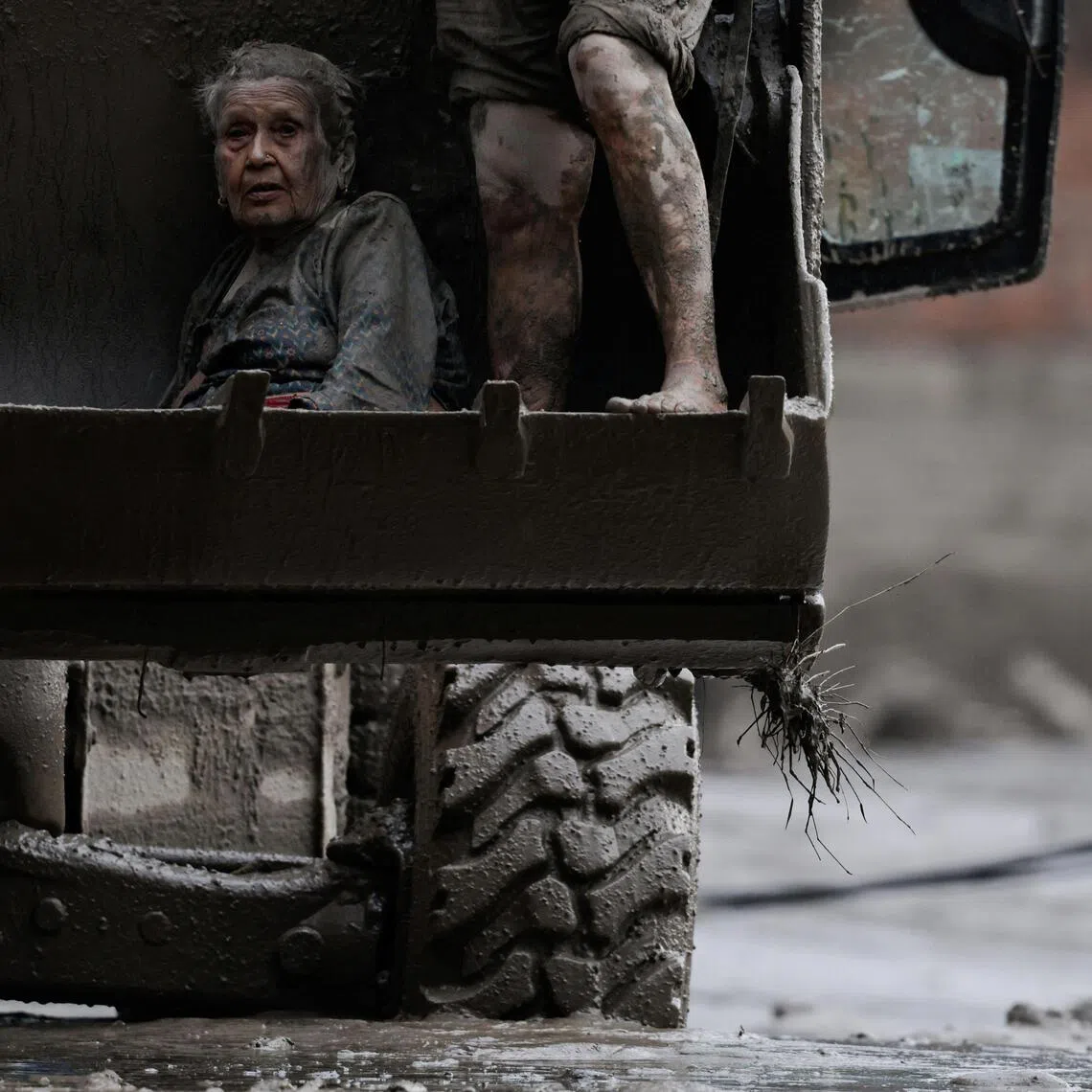 An elderly survivor is transported to a safer place on Aug 26, following flash floods and landslides in Nepal.
