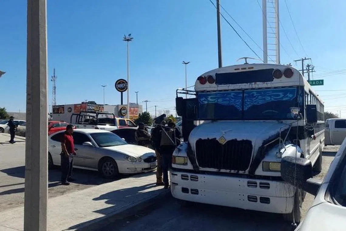 Police authorities stand outside a bus transporting the migrants who were kidnapped in the Mexican state of Tamaulipas, in the municipality of Rio Bravo, Mexico, January 3, 2024. Mexico Presidency/Handout via REUTERS