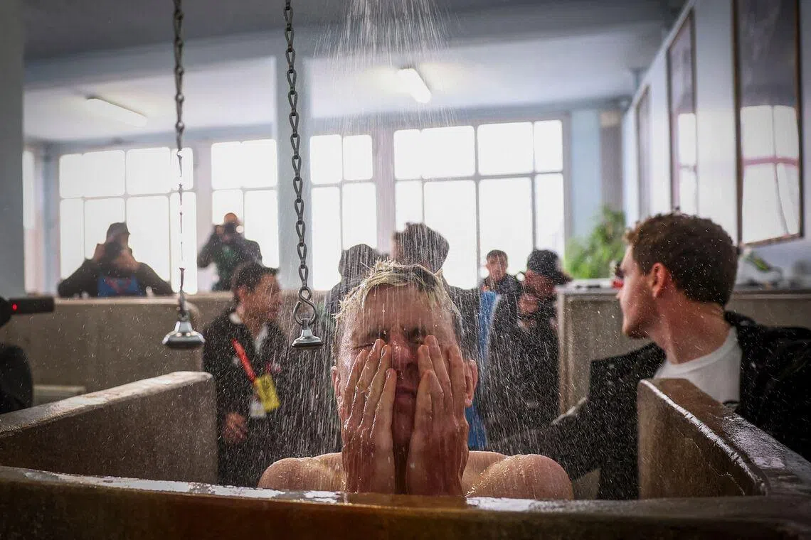 UAE Team Emirates XRG's Slovenian rider Tadej Pogacar taking a shower at the end of the 123rd edition of the Paris-Roubaix one-day classic cycling race, at the Vélodrome André-Pétrieux in Roubaix, northern France, on April 12, 2026. 