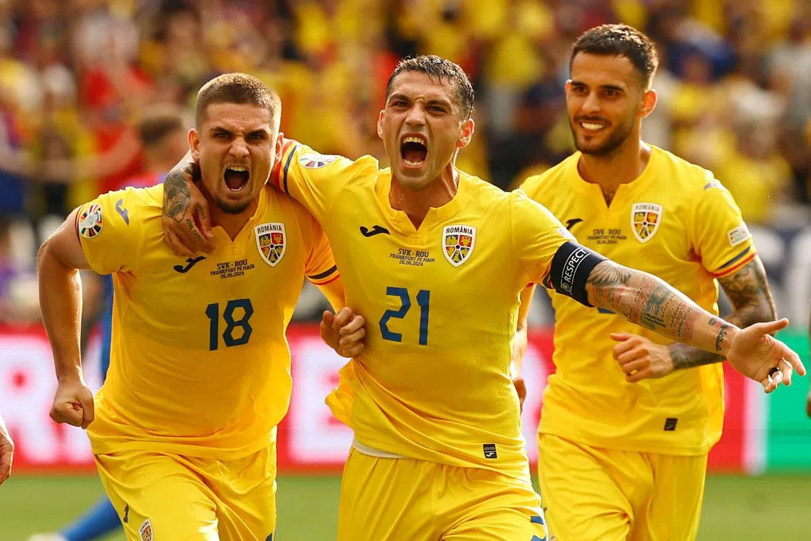 Soccer Football - Euro 2024 - Group E - Slovakia v Romania - Frankfurt Arena, Frankfurt, Germany - June 26, 2024 Romania's Razvan Marin celebrates scoring their first goal with Nicolae Stanciu REUTERS/Kai Pfaffenbach