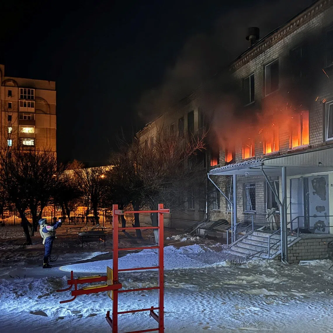 Emergency employees work at the site of a school hit during a Russian missile strike, amid Russia's attack on Ukraine, in Kharkiv, Ukraine January 26, 2026. Picture taken with a mobile phone. REUTERS/Vitalii Hnidyi