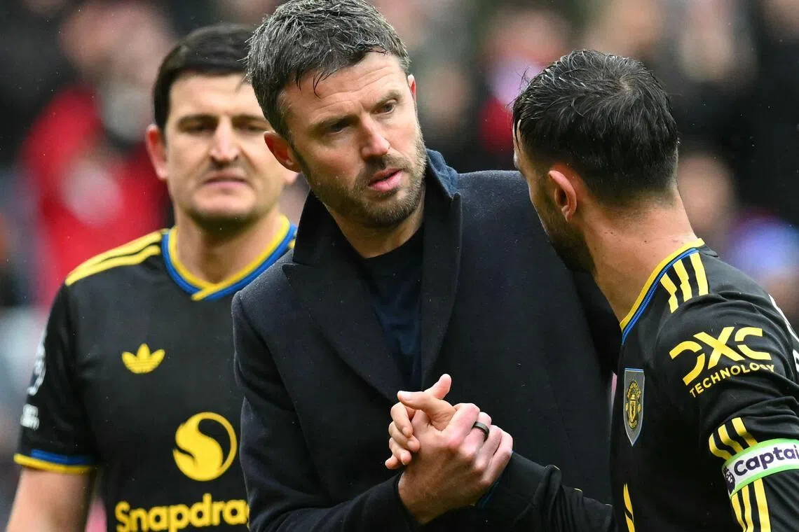 Manchester United's interim manager Michael Carrick clasping hands with Bruno Fernandes after the English Premier League match with Sunderland on May 9.